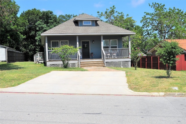 bungalow-style house with a porch and a front lawn