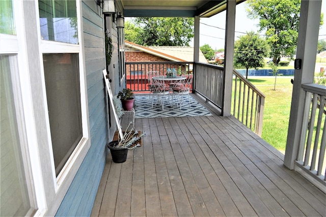 wooden deck with a lawn