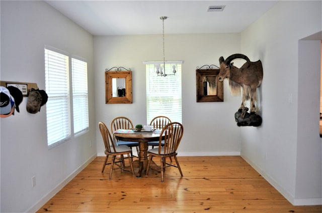 dining space featuring a chandelier and light hardwood / wood-style floors