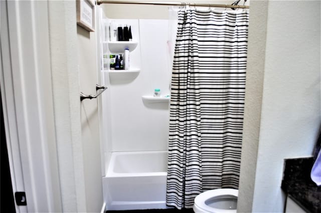 bathroom with shower / tub combo with curtain and toilet