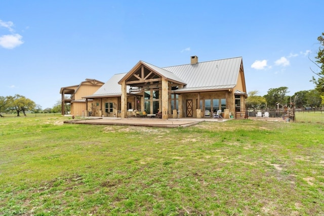 back of property featuring a lawn and a patio