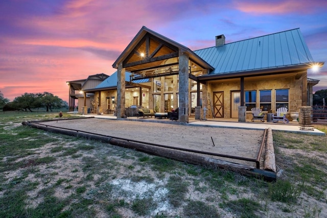 view of back house at dusk