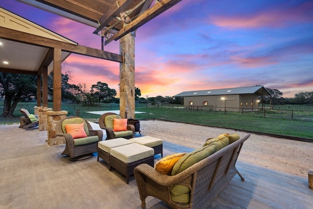 patio terrace at dusk with an outdoor living space and a deck