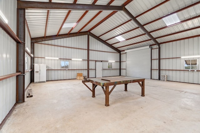 garage featuring white fridge with ice dispenser