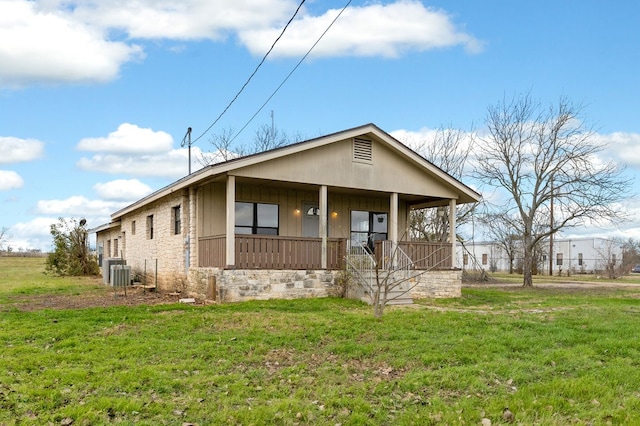 view of front of property with a porch, central AC, and a front yard