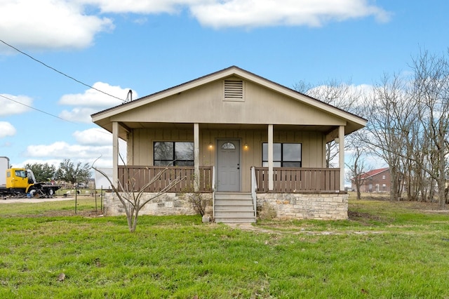 view of front of home with a front yard and a porch