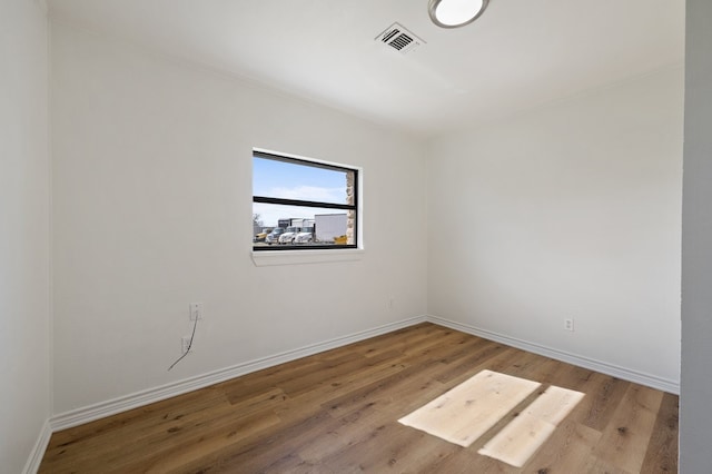 spare room featuring light hardwood / wood-style flooring