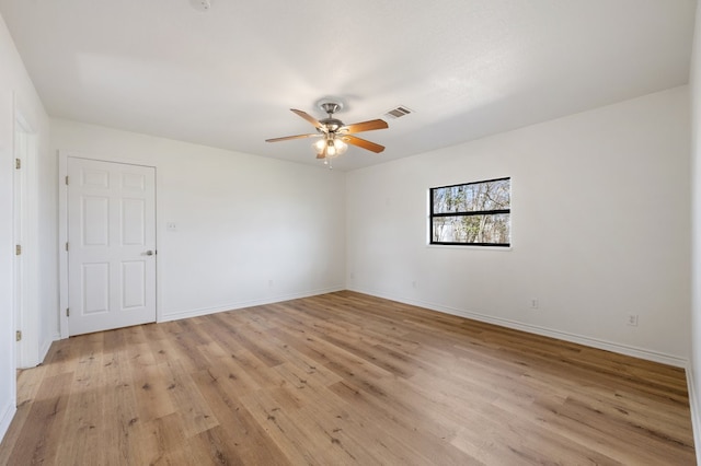 spare room featuring ceiling fan and light hardwood / wood-style flooring