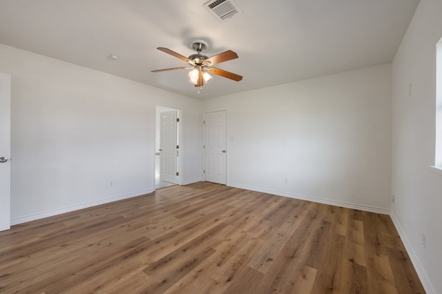 empty room with ceiling fan and dark hardwood / wood-style floors