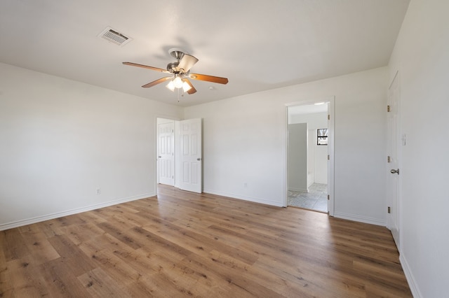 empty room featuring dark hardwood / wood-style flooring and ceiling fan