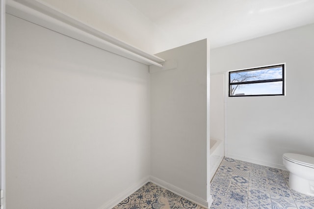 walk in closet featuring light tile flooring