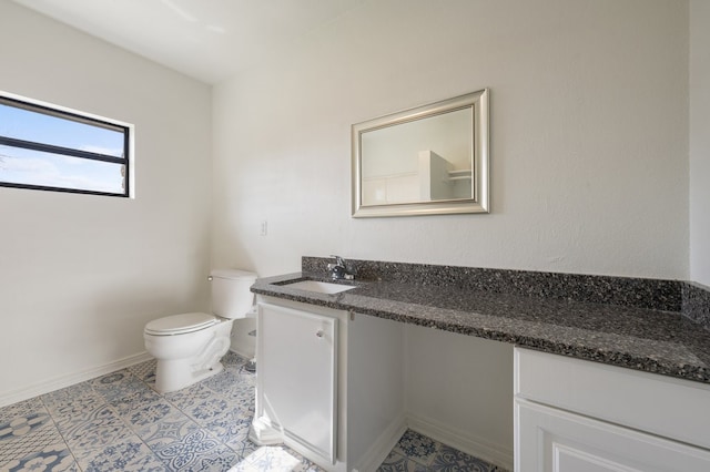 bathroom featuring tile floors, toilet, and vanity