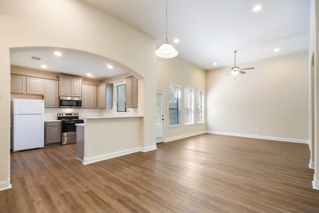 kitchen with ceiling fan, appliances with stainless steel finishes, dark wood-type flooring, tasteful backsplash, and decorative light fixtures