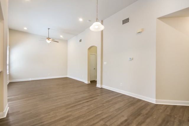 spare room with ceiling fan, high vaulted ceiling, and dark hardwood / wood-style flooring