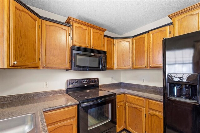 kitchen featuring black appliances and a textured ceiling