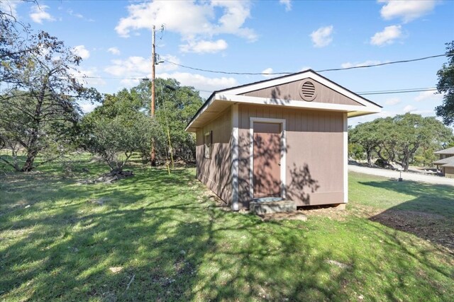 view of shed / structure with a yard