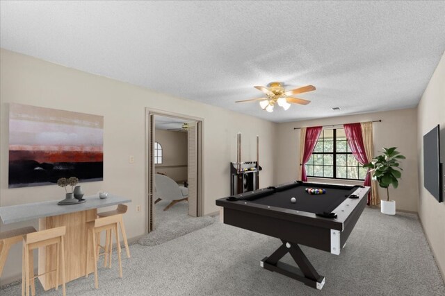 game room featuring billiards, carpet flooring, ceiling fan, and a textured ceiling