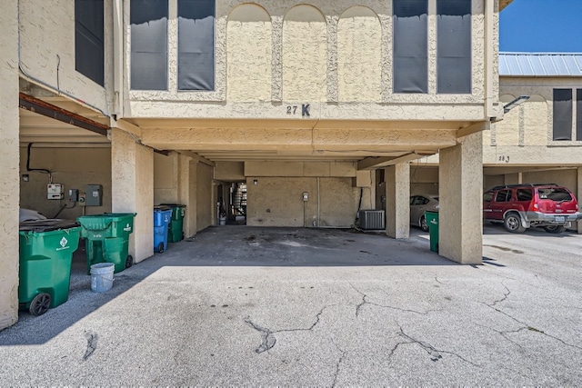 garage with central AC unit and a carport