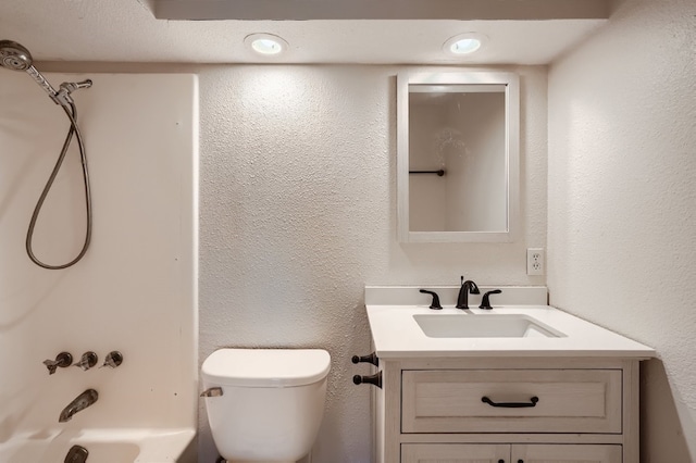 full bathroom with  shower combination, toilet, vanity, and a textured ceiling