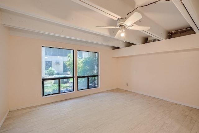 empty room featuring ceiling fan, beam ceiling, and light hardwood / wood-style floors