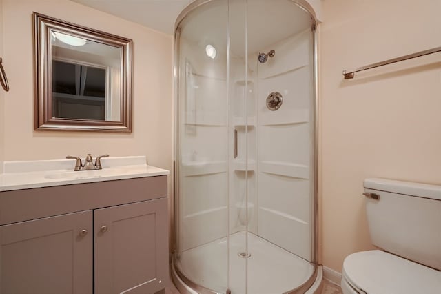 bathroom featuring vanity, toilet, and walk in shower