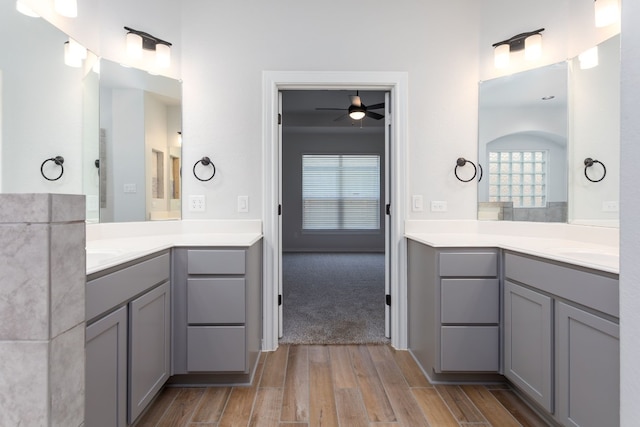 bathroom with vanity, ceiling fan, and wood-type flooring