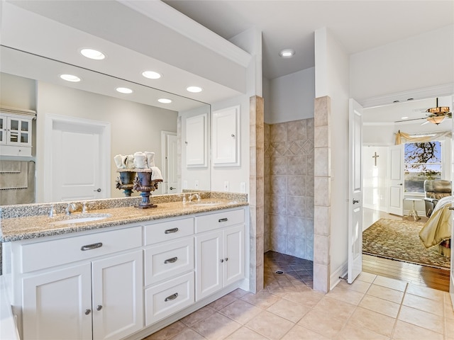 bathroom featuring tile patterned flooring, a sink, recessed lighting, and double vanity