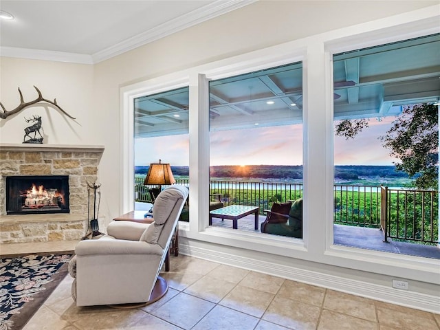 living area with baseboards, a fireplace, light tile patterned flooring, and crown molding