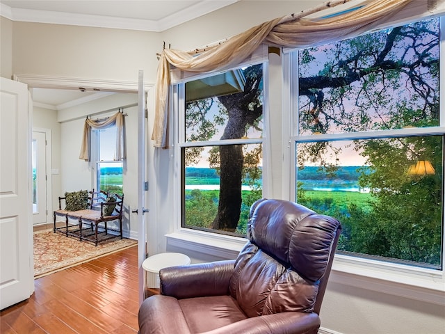 doorway to outside featuring crown molding and wood finished floors