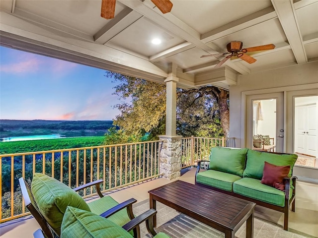 deck at dusk with an outdoor hangout area and a ceiling fan