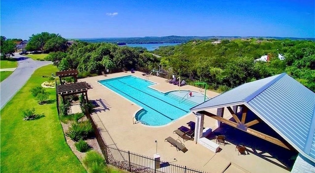 community pool with a gazebo, fence, a lawn, and a patio