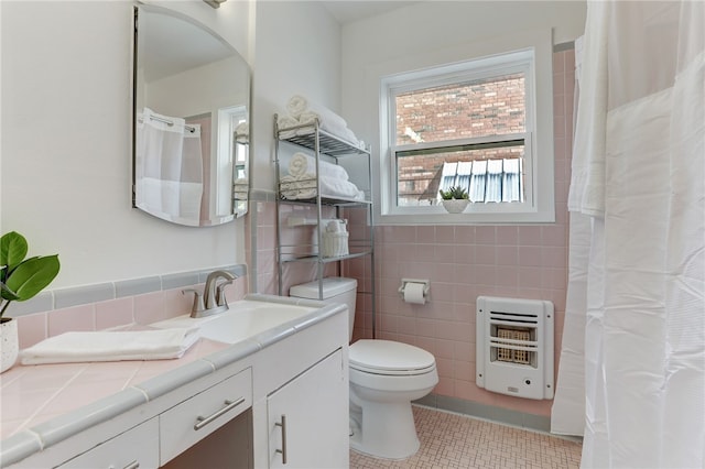 bathroom featuring tasteful backsplash, tile walls, toilet, tile patterned floors, and vanity