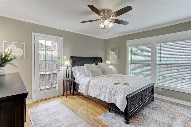 bedroom with ornamental molding, light wood-type flooring, and ceiling fan