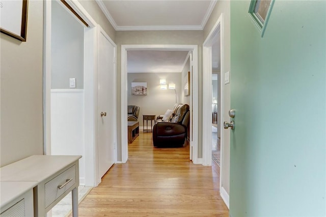 hallway featuring light wood-type flooring and crown molding