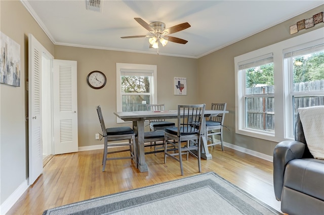 dining area with ceiling fan, light hardwood / wood-style flooring, and ornamental molding