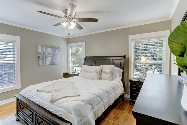 bedroom with ornamental molding, ceiling fan, and hardwood / wood-style floors