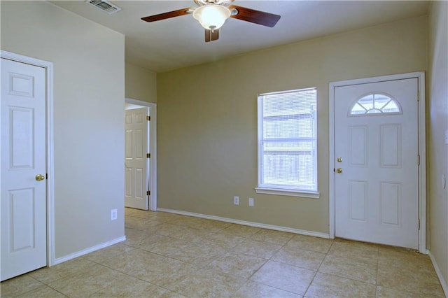 foyer with ceiling fan, light tile patterned floors, visible vents, and baseboards