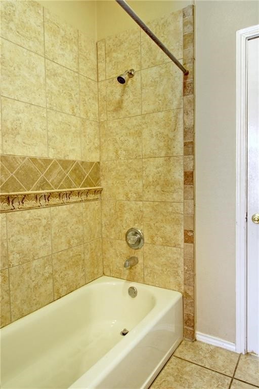 bathroom with tiled shower / bath and tile patterned floors