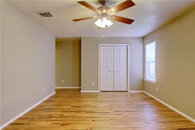 unfurnished room featuring ceiling fan and light wood-type flooring