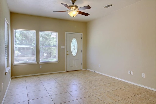 entrance foyer featuring light tile patterned floors, ceiling fan, visible vents, and baseboards