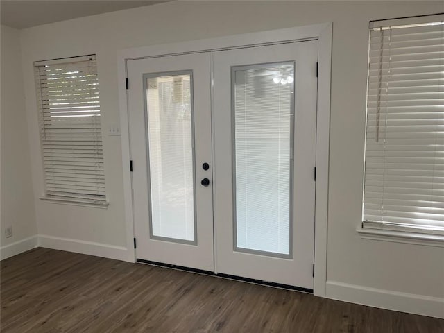 doorway to outside featuring french doors, dark wood finished floors, and baseboards