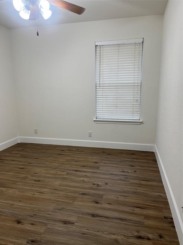 unfurnished room with dark wood-style floors, ceiling fan, and baseboards