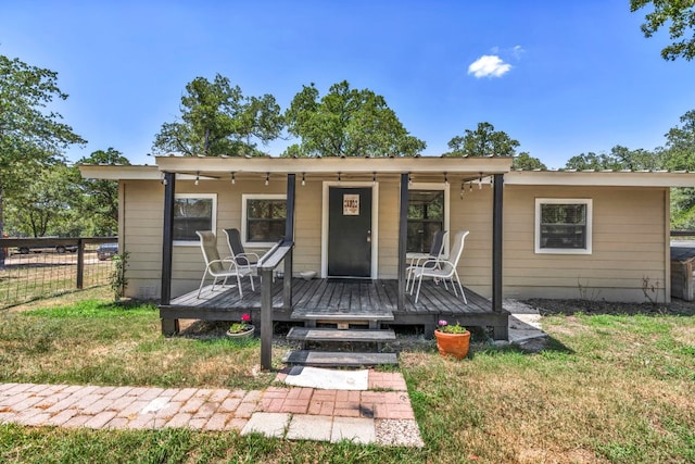 bungalow-style house featuring a front lawn and a deck