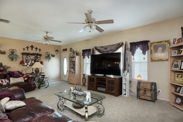 carpeted living room featuring ceiling fan and a wealth of natural light