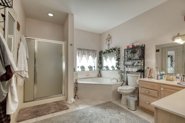 full bathroom featuring tile flooring, independent shower and bath, vanity with extensive cabinet space, and toilet