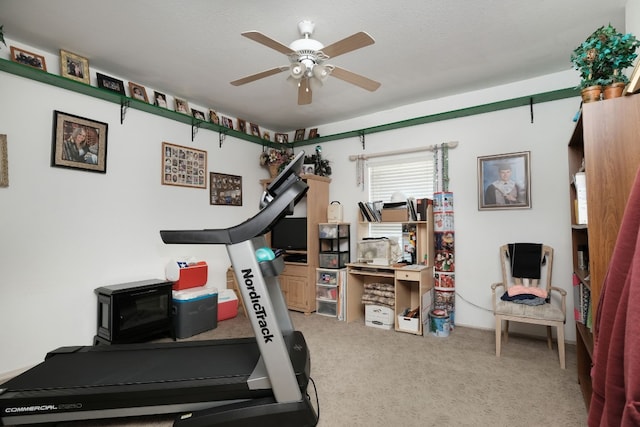 workout room featuring carpet and ceiling fan