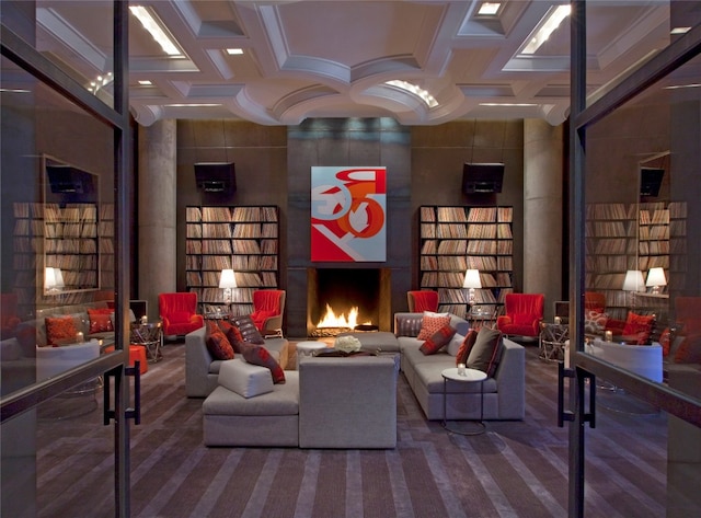 carpeted living room featuring coffered ceiling and a fireplace