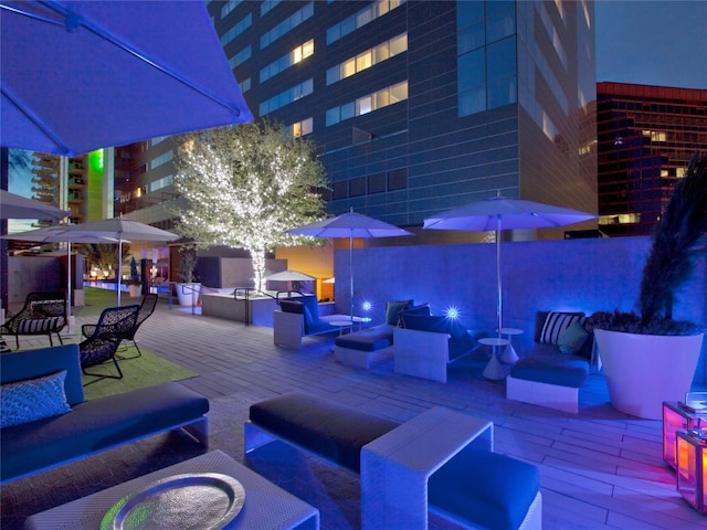 patio at twilight featuring an outdoor hangout area