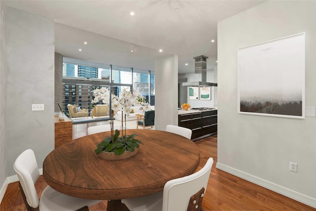 dining space with wood-type flooring