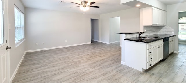 kitchen featuring ceiling fan, backsplash, light wood-type flooring, and white cabinetry